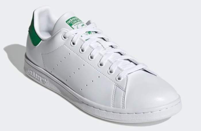 View of white and green adidas shoe.
